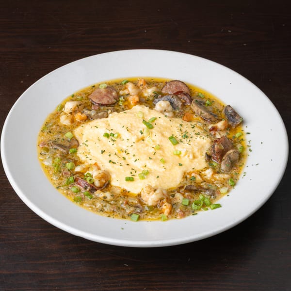 Rusty's Riverfront Grill's shrimp and grits with sausage, mushrooms, and green onions.